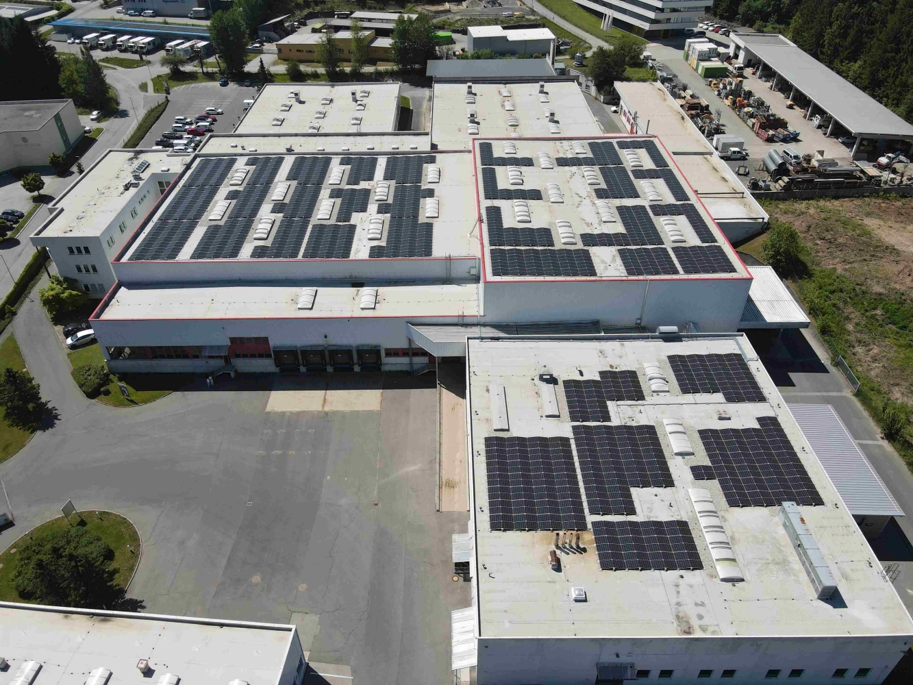 Luftaufnahme der Hallen mit Photovoltaikanlagen im Gewerbepark Wernberg bei Villach in K&auml;rnten